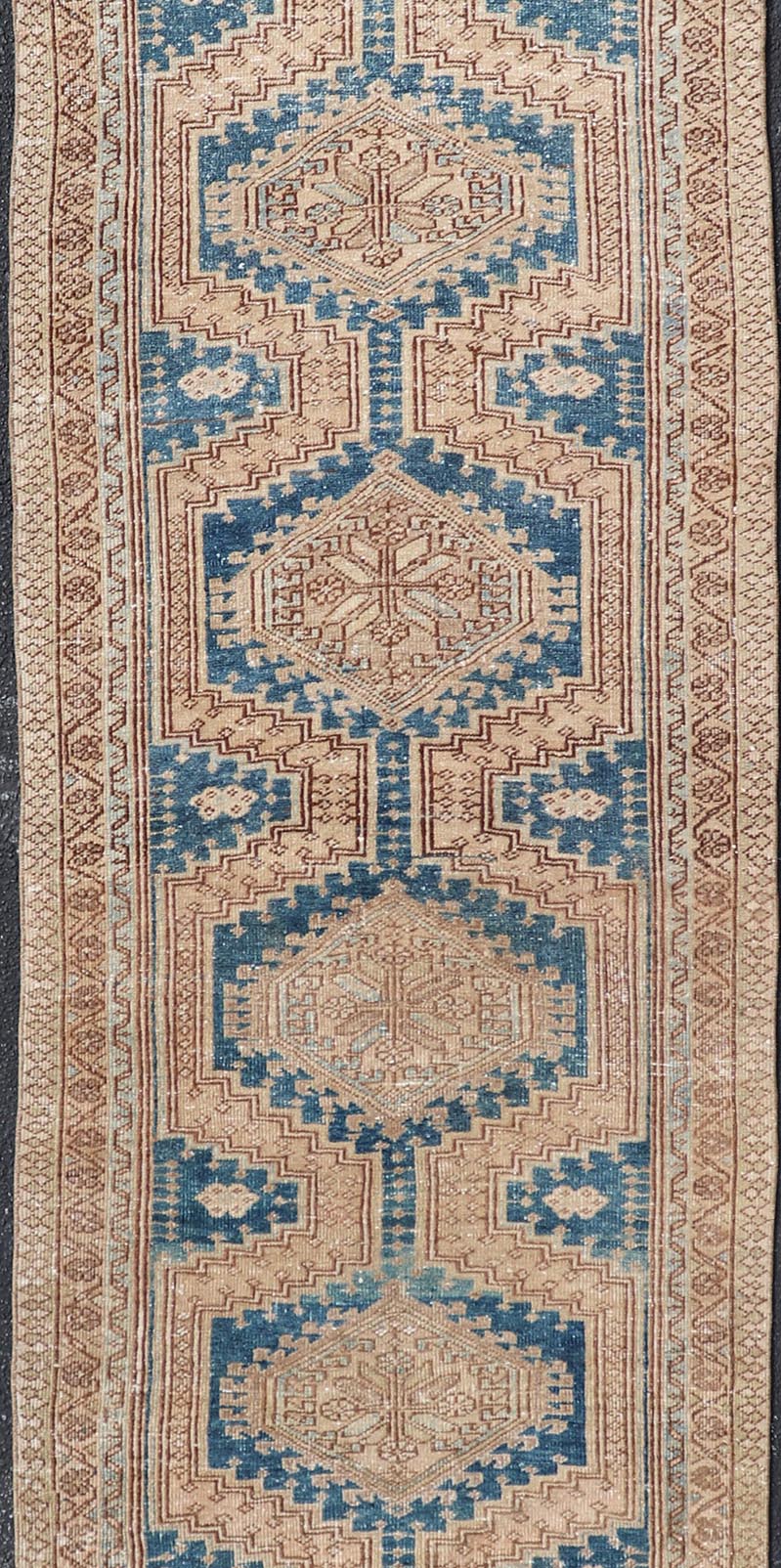 Measures: 3'0 x 10'10 This antique Persian Heriz runner with a distinctive and elegant design. The runner showcases a series of connected geometric medallions running along its length, each intricately detailed with traditional motifs. The central ... - Keivan Woven ArtsEMB - 22240 - 22484Rug