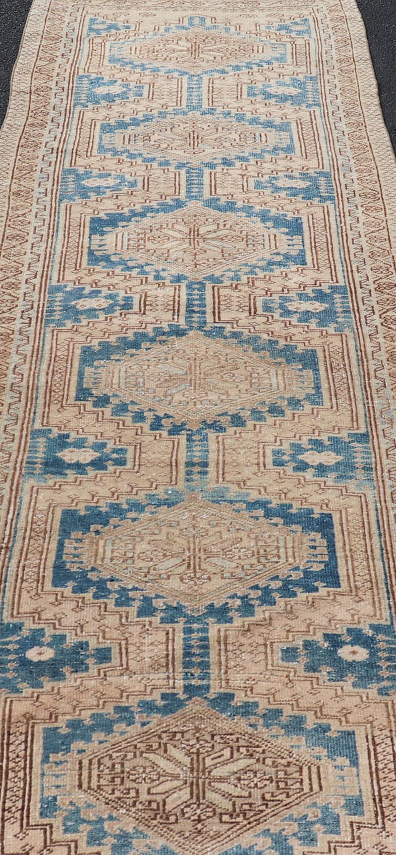 Measures: 3'0 x 10'10 This antique Persian Heriz runner with a distinctive and elegant design. The runner showcases a series of connected geometric medallions running along its length, each intricately detailed with traditional motifs. The central ... - Keivan Woven ArtsEMB - 22240 - 22484Rug