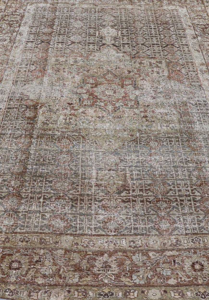 Antique Hand - Knotted Distressed Persian Mahal Rug in Wool with Medallion Design This antique distressed Persian Mahal rug has been hand - knotted in wool and features a large medallion design rendered in muted tones, a complementary, multi - tiered... - Keivan Woven ArtsEMB - 5000 - P13060 - 16406Rug