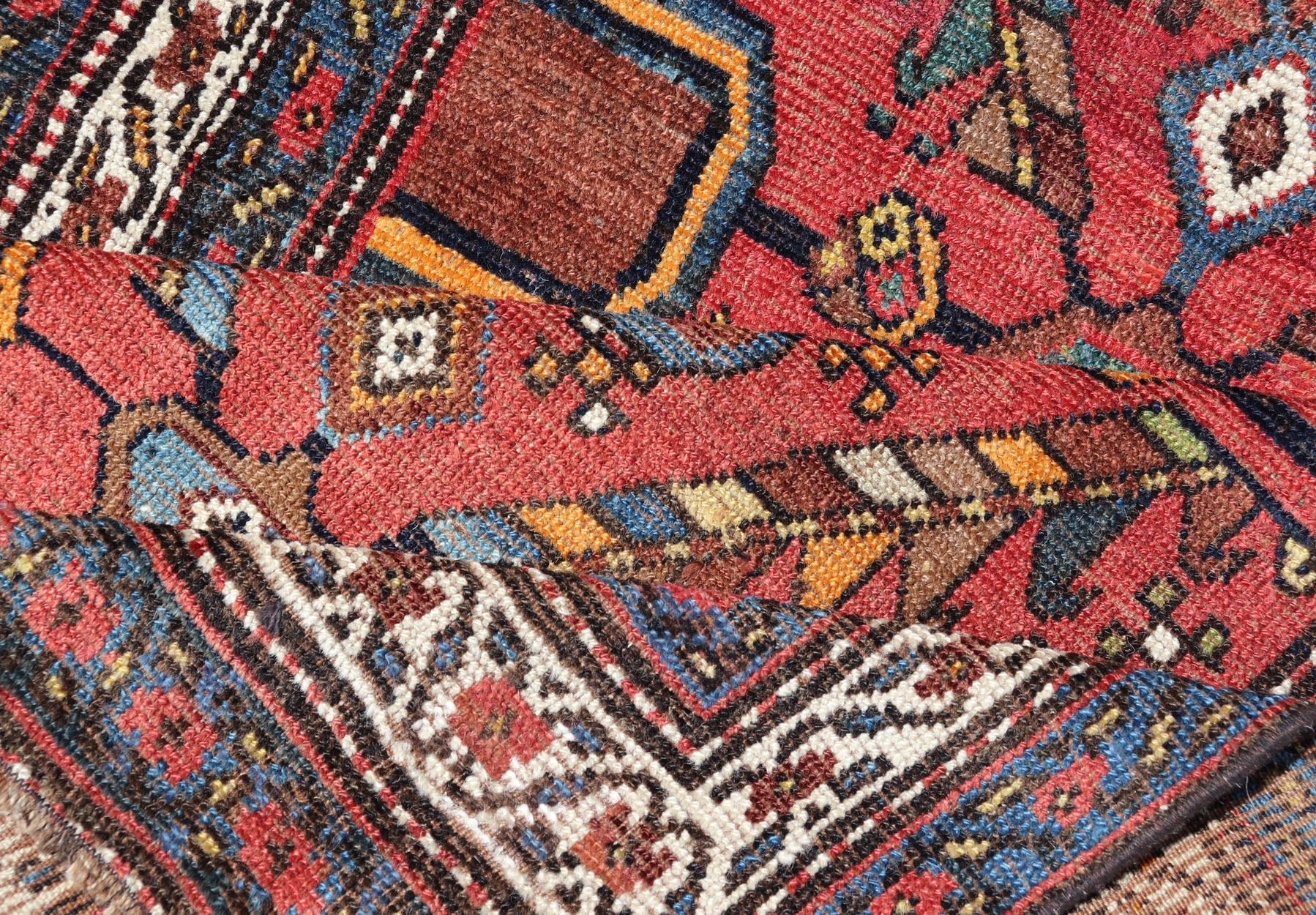 Kurdish Antique Runner in Vibrant Red Background and Multi - tiered Border This early 20th century antique Kurdish runner features a triple - lined floral border, emboldening an ivory stripe between two blue edges. The field features a tribal, sub - g... - Keivan Woven ArtsEMB - 9523 - P13064 - 14668Rug
