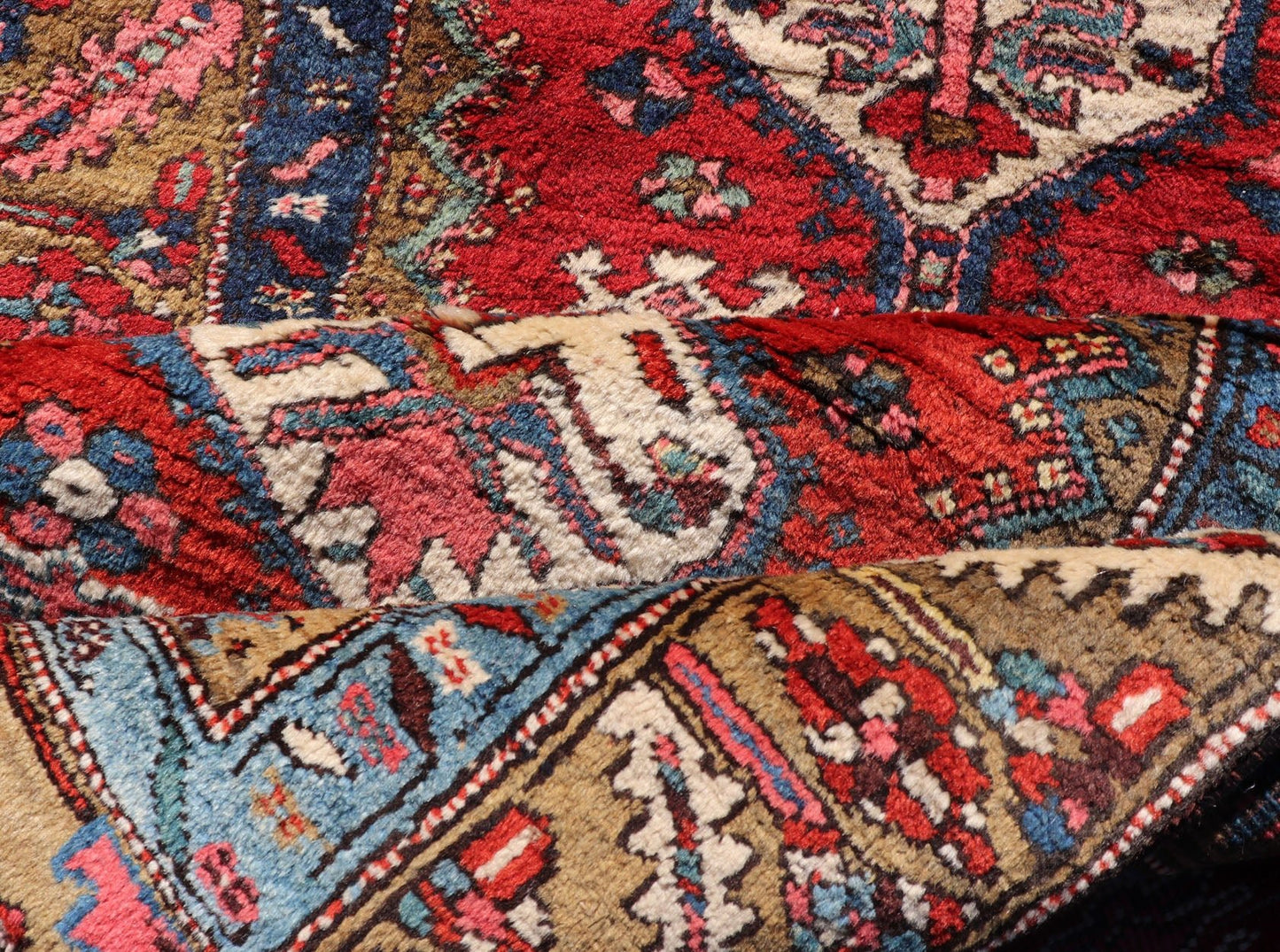 Antique Persian Heriz Runner in Reds, Blues, Pink, Ivory and Earthy Tones This gorgeous antique Persian Heriz runner features a red background imbued with ornate medallions running along the piece. Sub - geometric designs decorate the field, and a... - Keivan Woven ArtsEMB - 9577 - P13510 - 15128Rug