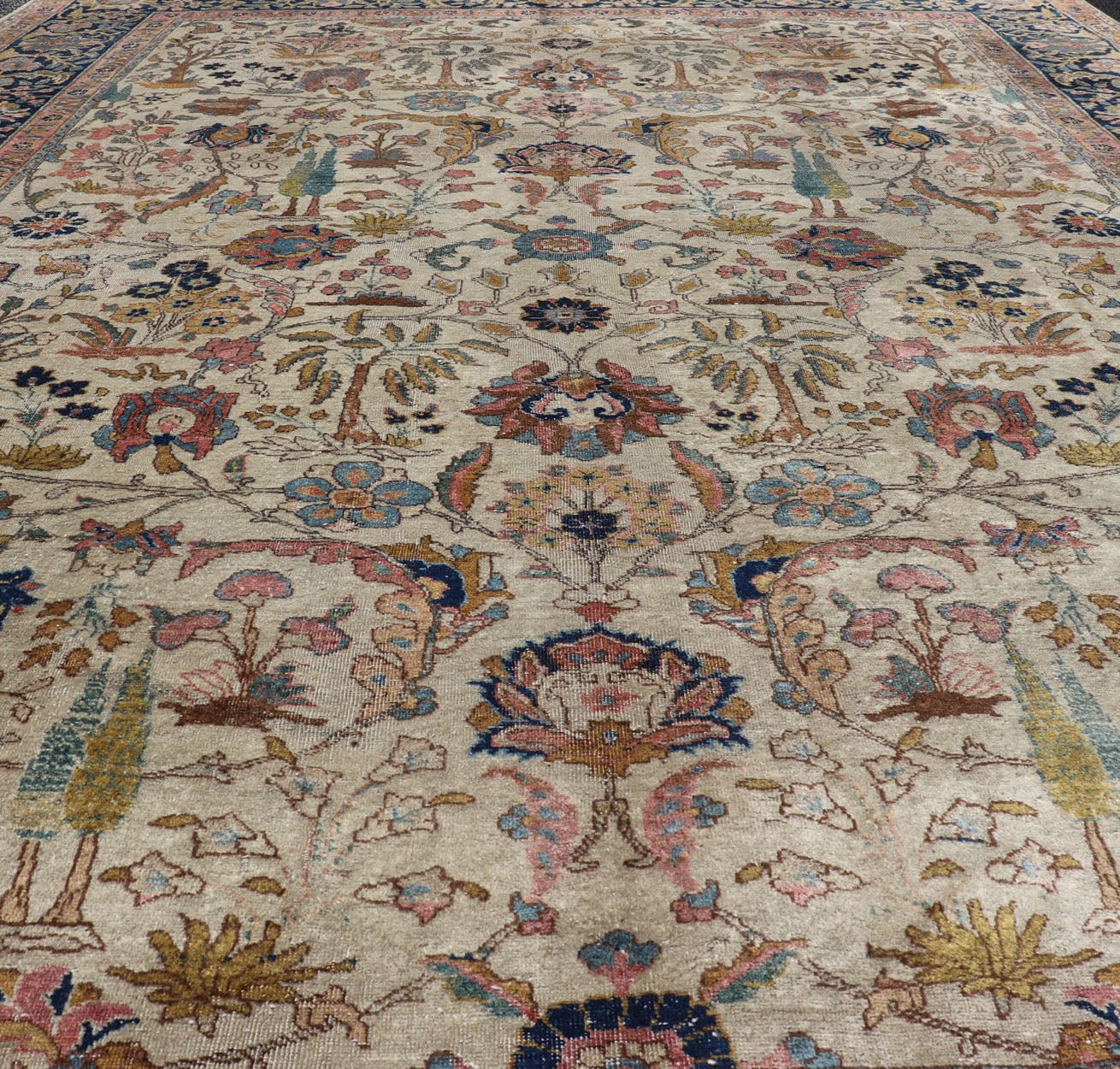 Antique Tabriz with All - Over Floral Sub - Geometric Design & Complementary Border This stunning Antique Tabriz rug (circa 1920s) features a lovely all - over floral design rendered in gold, coral, shades of blue, and pink set upon an Ivory backgroun... - Keivan Woven ArtsEMB - 9593 - P13518 - 15607Rug