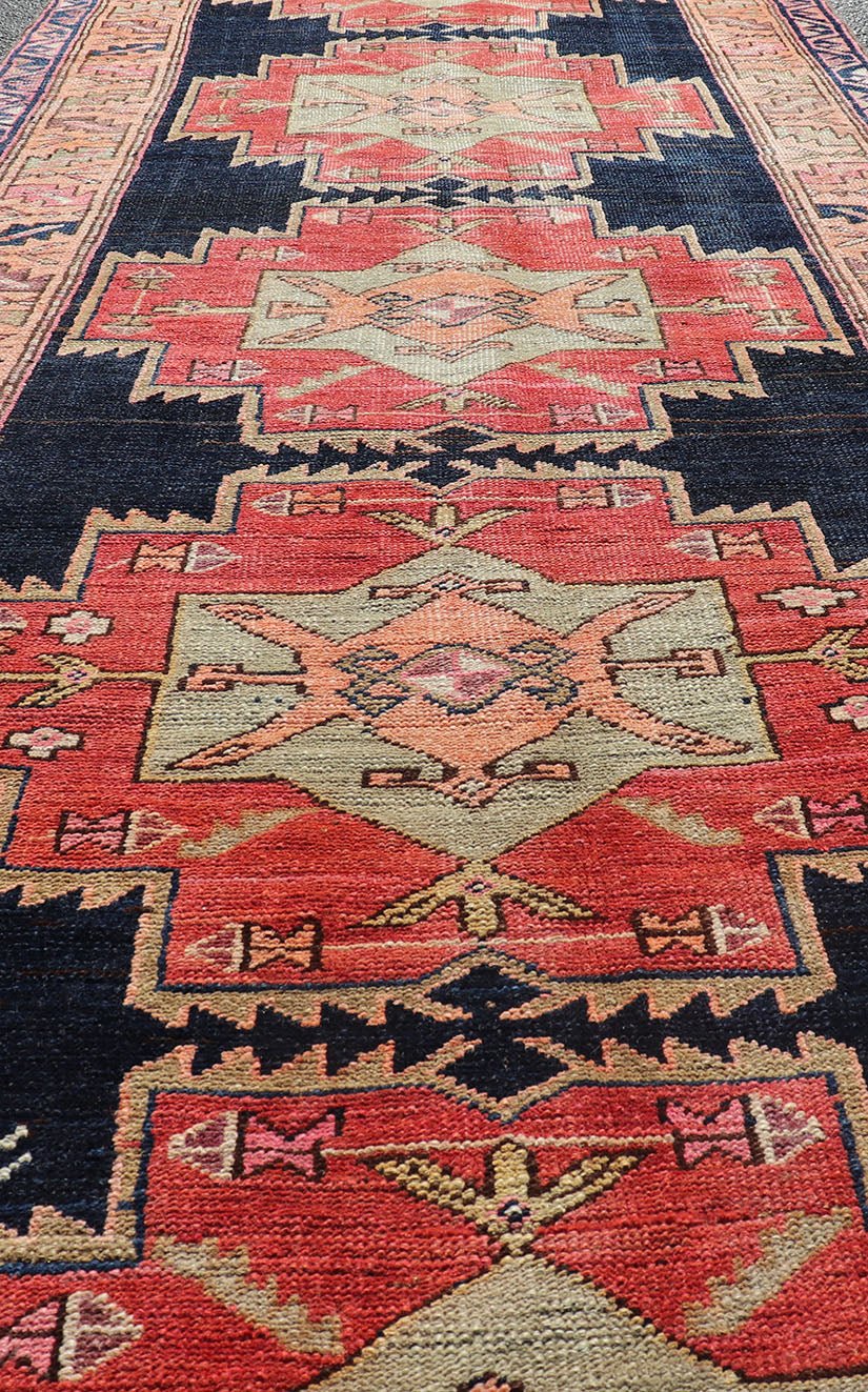 Long Hand - Knotted Antique Persian Azerbaijan Runner in Wool with Medallions This antique Persian Azerbaijan styled runner has been hand - knotted in wool. The rug features a sub - geometric medallion design, and is enclosed within a complementary, ... - Keivan Woven ArtsEMB - 9608 - P13508 - 15661Rug