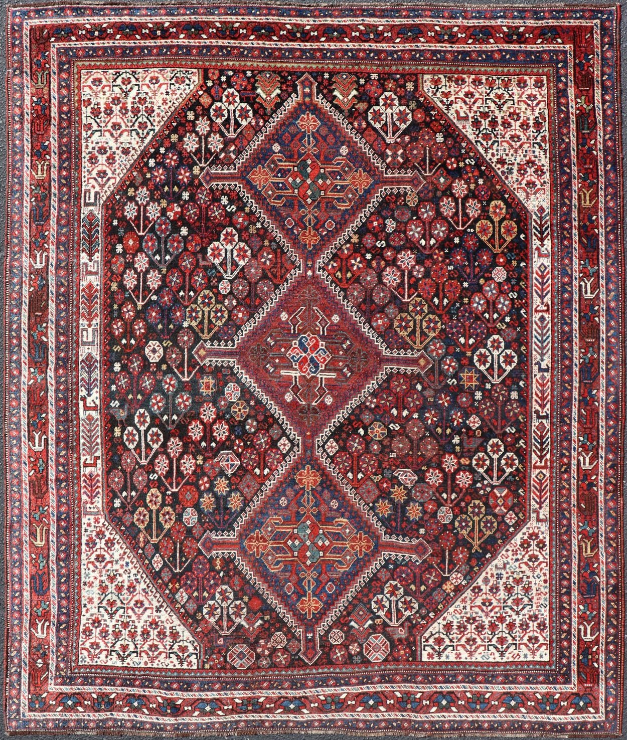 Antique Hand - Knotted Persian Qashqai Rug in Wool with All - Over Tribal Design This antique Persian Qashqai rug has been hand - knotted in wool and features an all - over sub - geometric design rendered in multicolor. A complementary, multi - tiered borde... - Keivan Woven ArtsEMB - 9628 - P13856 - 16007Rug