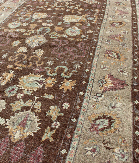 Vintage Turkish Oushak Rug in Brown Background with All - Over Floral Design Measures: 4'5 x 8'3 This Turkish Oushak is set on a chocolate - brown background and features a light gray/taupe border. The overall palette remains cool, with accent colors... - Keivan Woven ArtsEN - 1025 - 3844