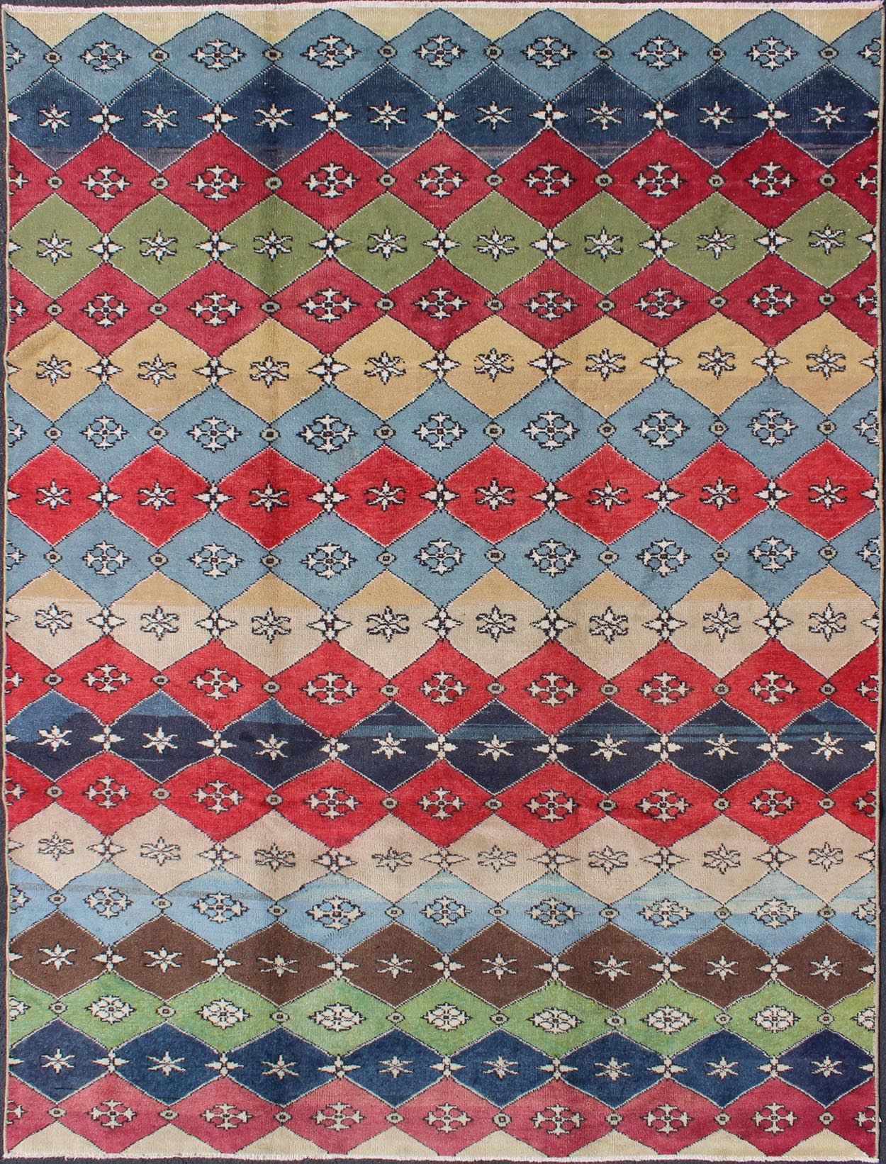 Mid - Century Rug Rendered with a multi - colored background and a spotted and speckled assortment of yellow, blue, green, red and brown colors, this very unique Mid Century rug has diamonds shapes that vary in color. Measures: 6`6 x 9` - Keivan Woven ArtsEN - 11037 - 5275Rug