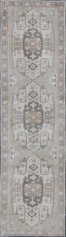 Turkish Oushak Runner with Central Medallion Design in Taupe, Charcoal and Gray kwarugs This Turkish vintage Oushak runner features a central medallion design as well as patterns of smaller botanical elements. Colors include various shades o... - Keivan Woven ArtsEN - 115826 - 2093Rug