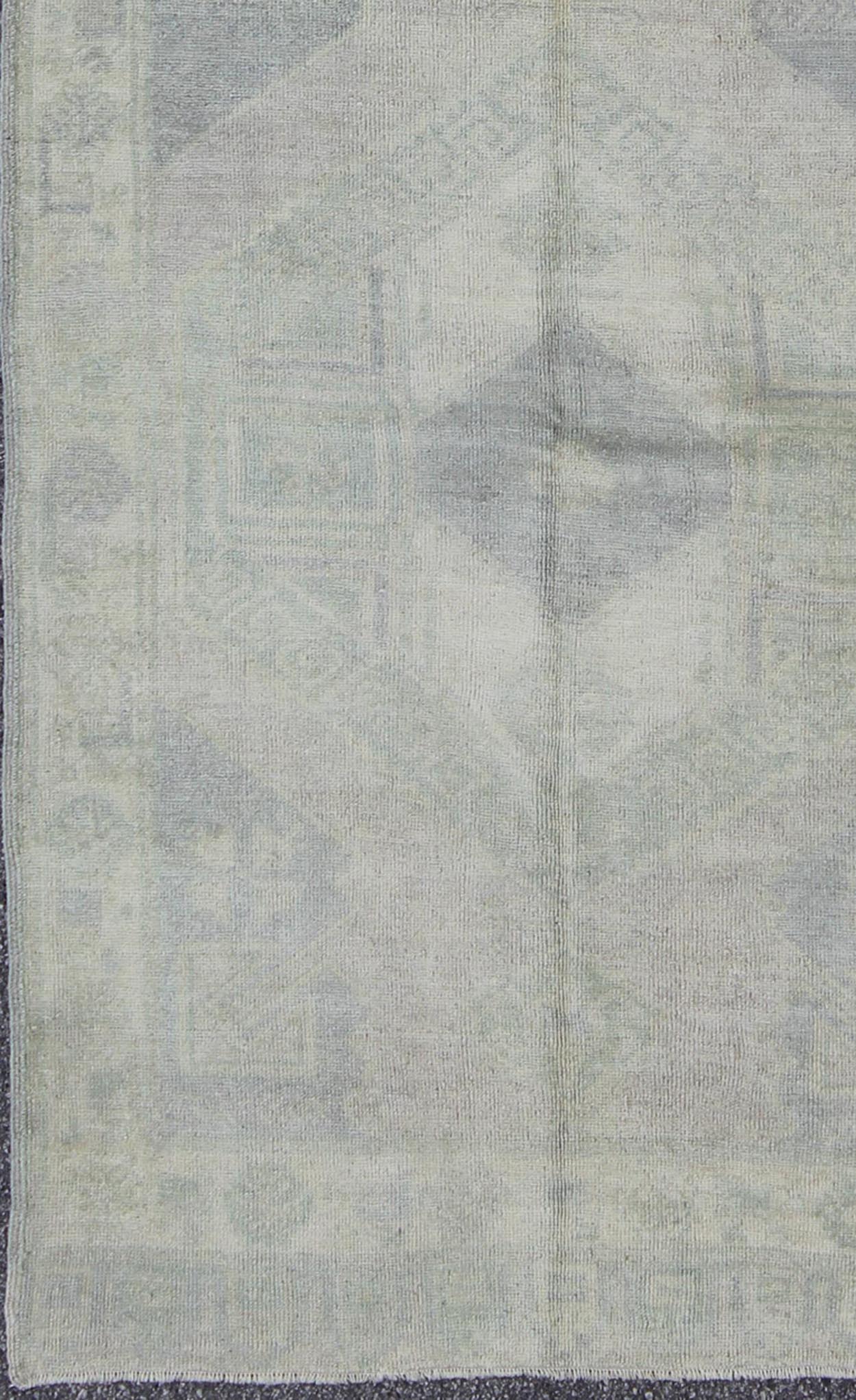 Muted Turkish Oushak Carpet with Two Diamond Medallions in Blue and Gray This Turkish Oushak carpet features a design with two central medallions, as well as patterns of smaller all - over diamonds and scattered sprays of vine scroll and palmettes... - Keivan Woven ArtsEN - 140440 - 6362Rug