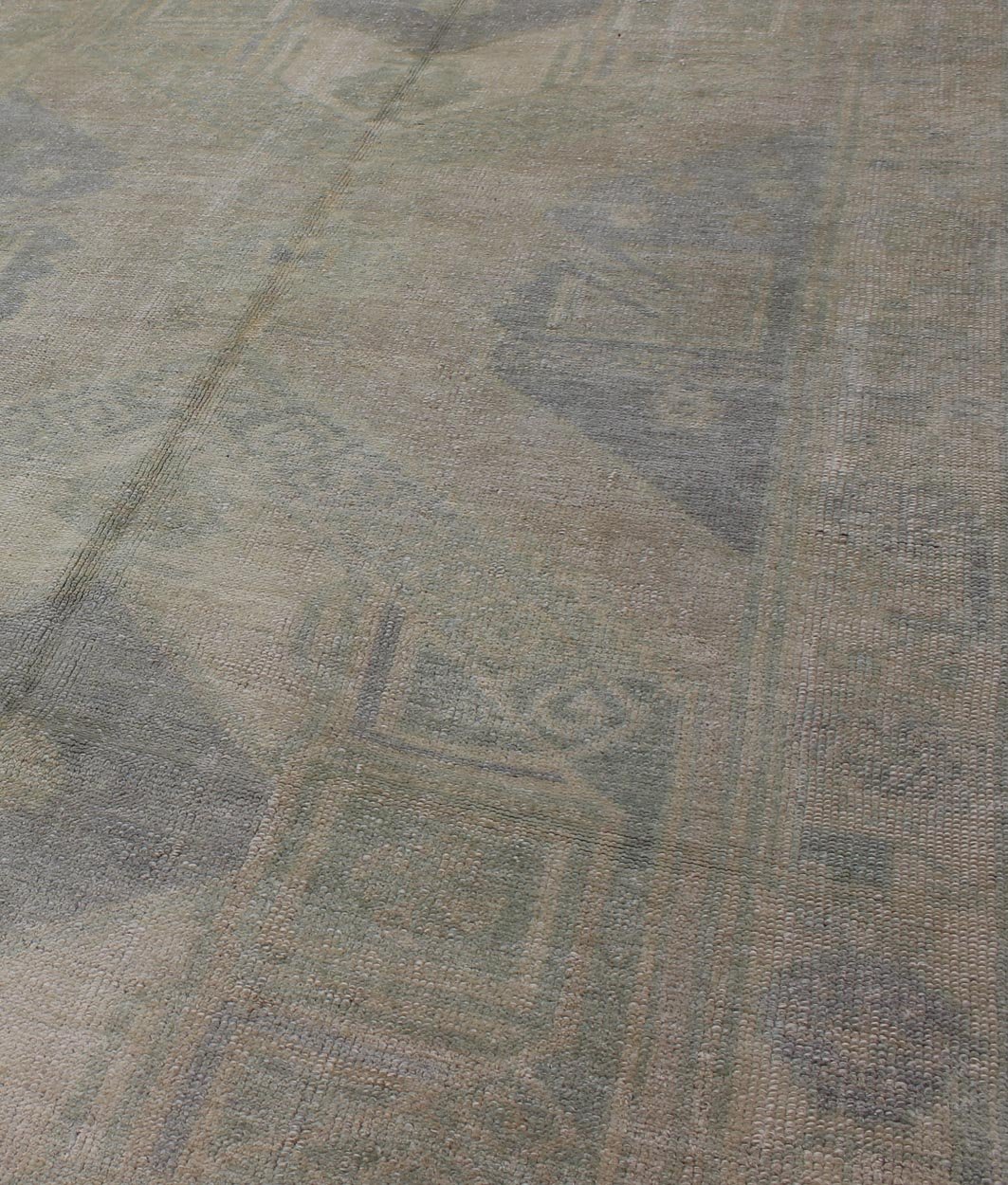 Muted Turkish Oushak Carpet with Two Diamond Medallions in Blue and Gray This Turkish Oushak carpet features a design with two central medallions, as well as patterns of smaller all - over diamonds and scattered sprays of vine scroll and palmettes... - Keivan Woven ArtsEN - 140440 - 6362Rug