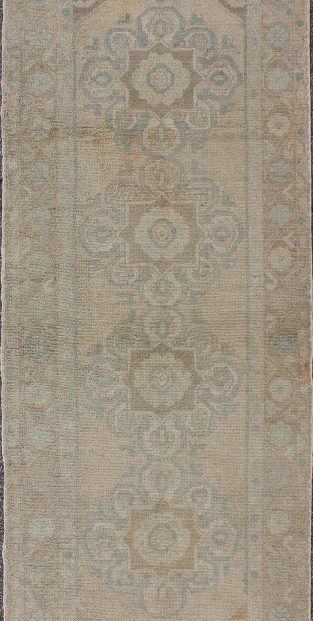 Floral medallion vintage Turkish Oushak runner with faded color palette, rug en - 140461, country of origin / type: Turkey / Oushak, circa 1930 This vintage Turkish Oushak gallery rug (1930) features a unique blend of colors and an intricately bea... - Keivan Woven ArtsEN - 140461 - 6049Rug