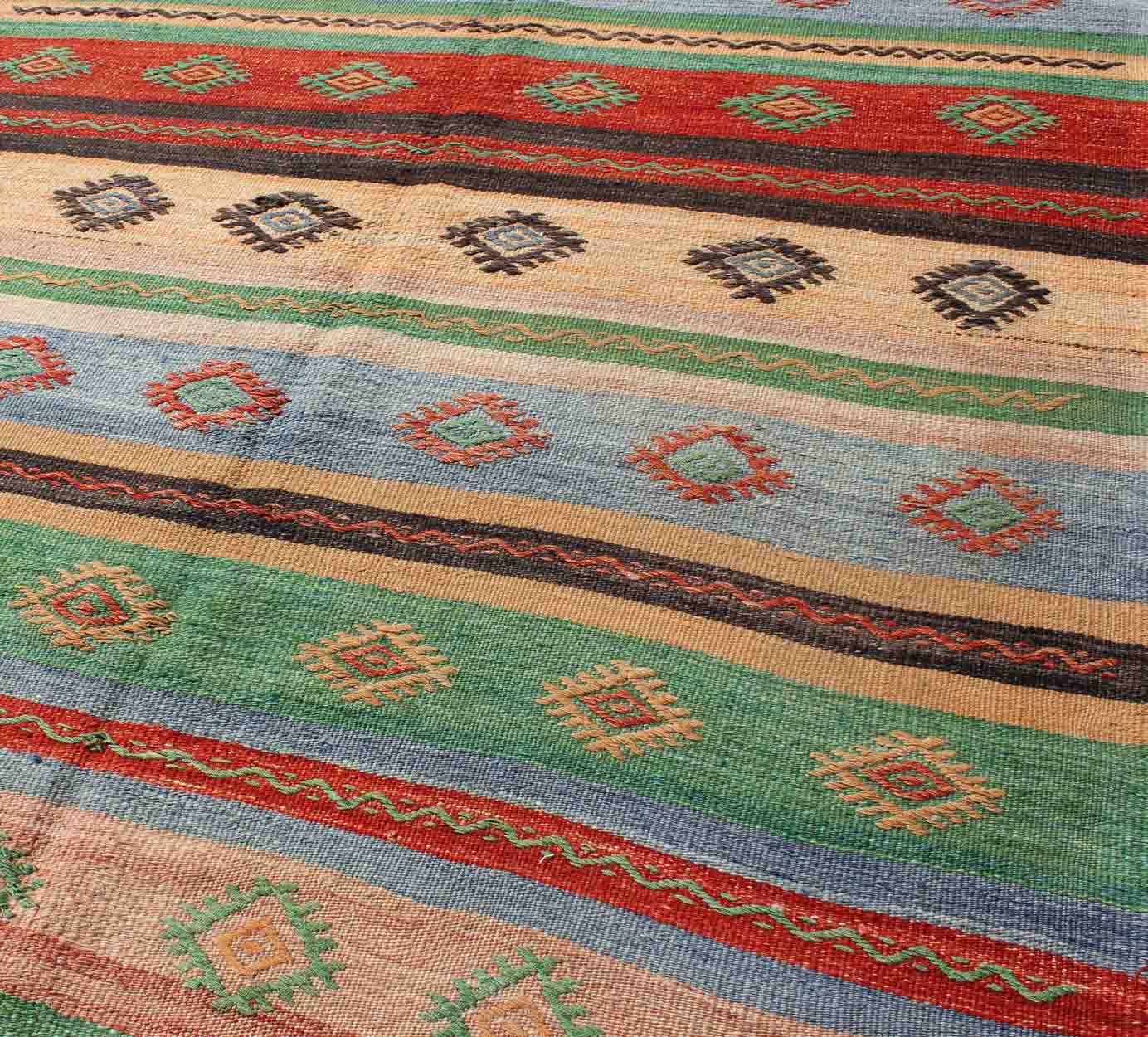 Vintage Turkish Kilim Carpet with Colorful Geometric Stripe Design. Vintage Hand - Knotted Turkish Kilim with Geometric Stripes, rug EN - 140519, country of origin / type: Turkey / Oushak, circa mid - 20th century. Featuring tribal shapes with a sp... - Keivan Woven ArtsEN - 140519 - 6061Rug