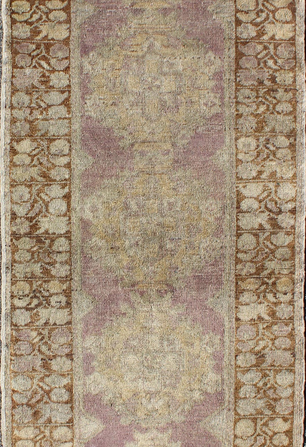 Vintage Oushak Runner This unique Turkish Oushak runner displays an elegant multi floral medallions which are complemented by a Sub geometric border. This rug has light purple background with dark brown, light blue, cream, green and taupe. Me... - Keivan Woven ArtsEN - 140539 - 6077Rug
