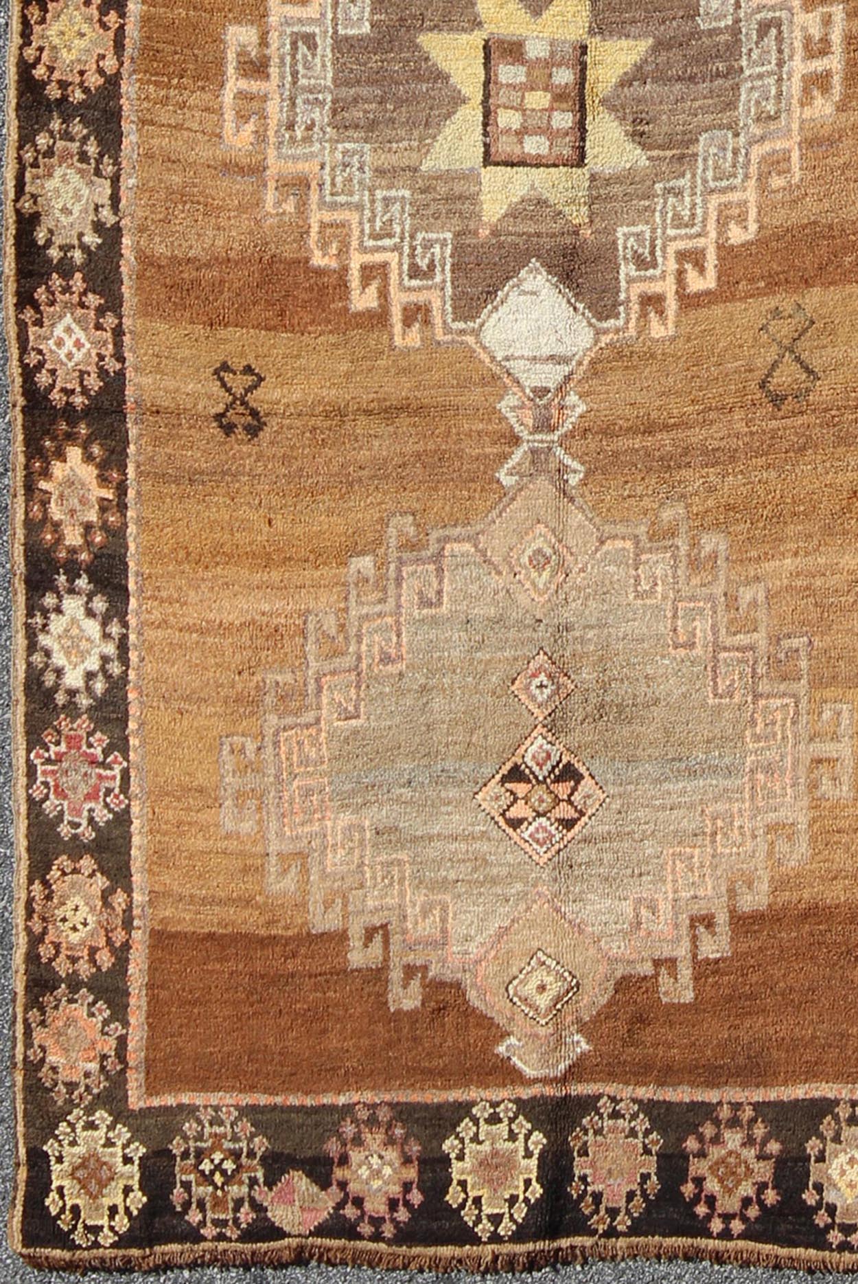 Vintage Turkish Kars Tribal Medallion Runner in Camel, Brown, and Taupe Measures: 4'6 x 10'11 This Kars Oushak features a triple center medallion with an overall geometric design scheme. The camel colored background homes three large tri... - Keivan Woven ArtsEN - 140562 - 5684Rug
