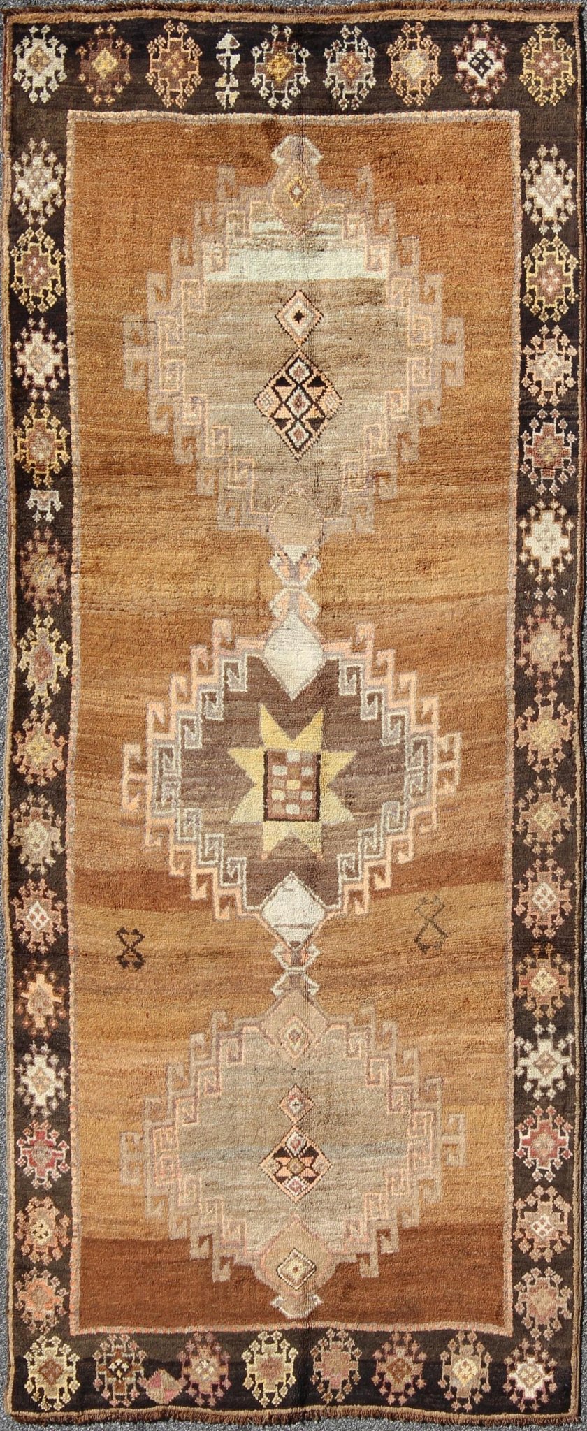 Vintage Turkish Kars Tribal Medallion Runner in Camel, Brown, and Taupe Measures: 4'6 x 10'11 This Kars Oushak features a triple center medallion with an overall geometric design scheme. The camel colored background homes three large tri... - Keivan Woven ArtsEN - 140562 - 5684Rug