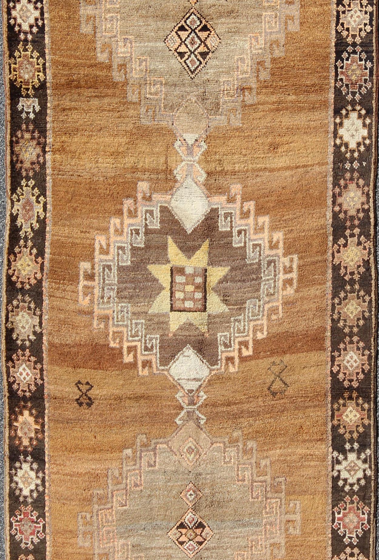 Vintage Turkish Kars Tribal Medallion Runner in Camel, Brown, and Taupe Measures: 4'6 x 10'11 This Kars Oushak features a triple center medallion with an overall geometric design scheme. The camel colored background homes three large tri... - Keivan Woven ArtsEN - 140562 - 5684Rug