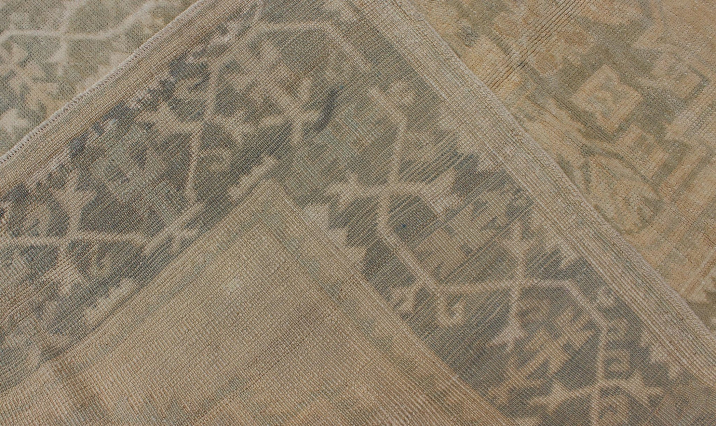 Medallion Vintage Turkish Oushak Rug in Taupe, Green and Sand Colors This vintage Turkish Oushak rug (circa mid - 20th century) features a unique blend of colors and an intricately beautiful design. The central three medallions, two more faint tha... - Keivan Woven ArtsEN - 141655 - 6710Rug