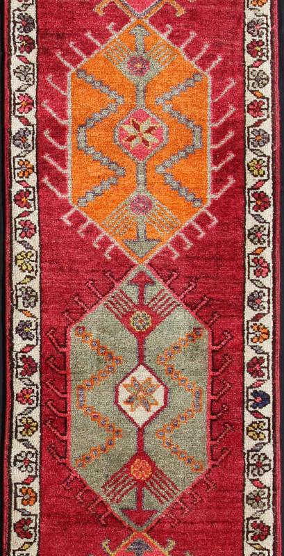 Vintage Turkish Oushak Runner with Bright and Colorful Medallion Design Measures: 2'10'' x 12'10''. This Oushak carpet from mid - 20th century Turkey features a stunning multi - medallion design rendered in geometric patterns enclosed within a re... - Keivan Woven ArtsEN - 142216 - 7727Rug