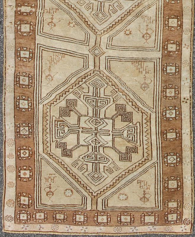 Brown, Camel, Ivory Long Turkish Oushak Runner with Geometric Tribal Medallions This vintage Turkish Oushak gallery rug (circa mid - 20th century) features a unique blend of colors and an intricately beautiful design. The central medallions consis... - Keivan Woven ArtsEN - 142368 - 8379Rug
