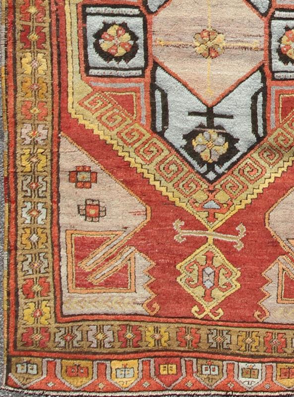 Vintage Turkish Hand Knotted Oushak Long Gallery Rug With Two Tribal Medallions The various shades of red pair elegantly with the bold tones of light blue, yellow and charcoal, laid out over two large tribal medallions with motifs in the field.... - Keivan Woven ArtsEN - 142374 - 8062Rug