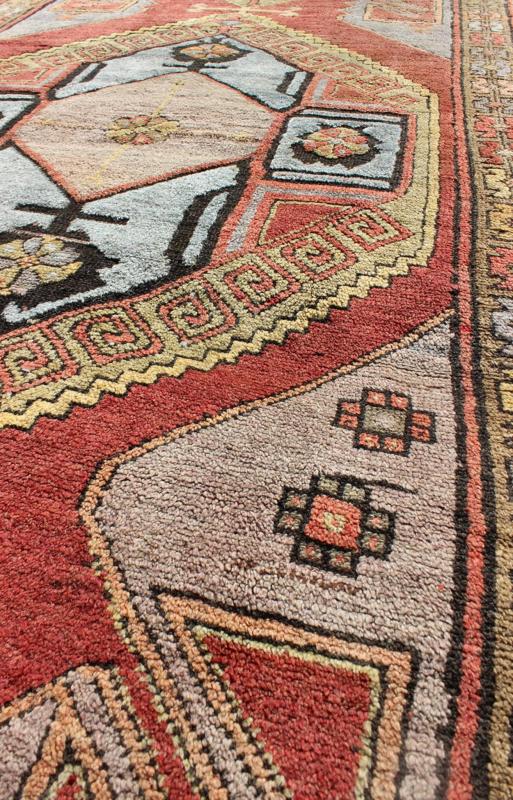 Vintage Turkish Hand Knotted Oushak Long Gallery Rug With Two Tribal Medallions The various shades of red pair elegantly with the bold tones of light blue, yellow and charcoal, laid out over two large tribal medallions with motifs in the field.... - Keivan Woven ArtsEN - 142374 - 8062Rug