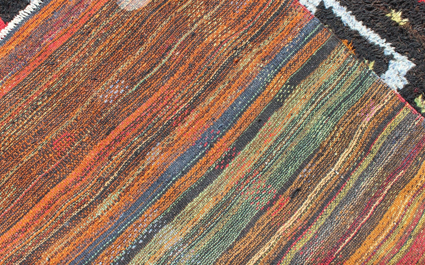 Vintage Turkish Tulu Rug with Tribal Pattern in Black, Yellow, Red, Blue and Red. Keivan Woven Arts / rug EN - 142568, country of origin / type: Turkey / Tulu, circa mid - 20th century Measures: 3'11 x 5'11. This vintage Tulu from mid - 20th century Tu... - Keivan Woven ArtsEN - 142568 - 7859Rug