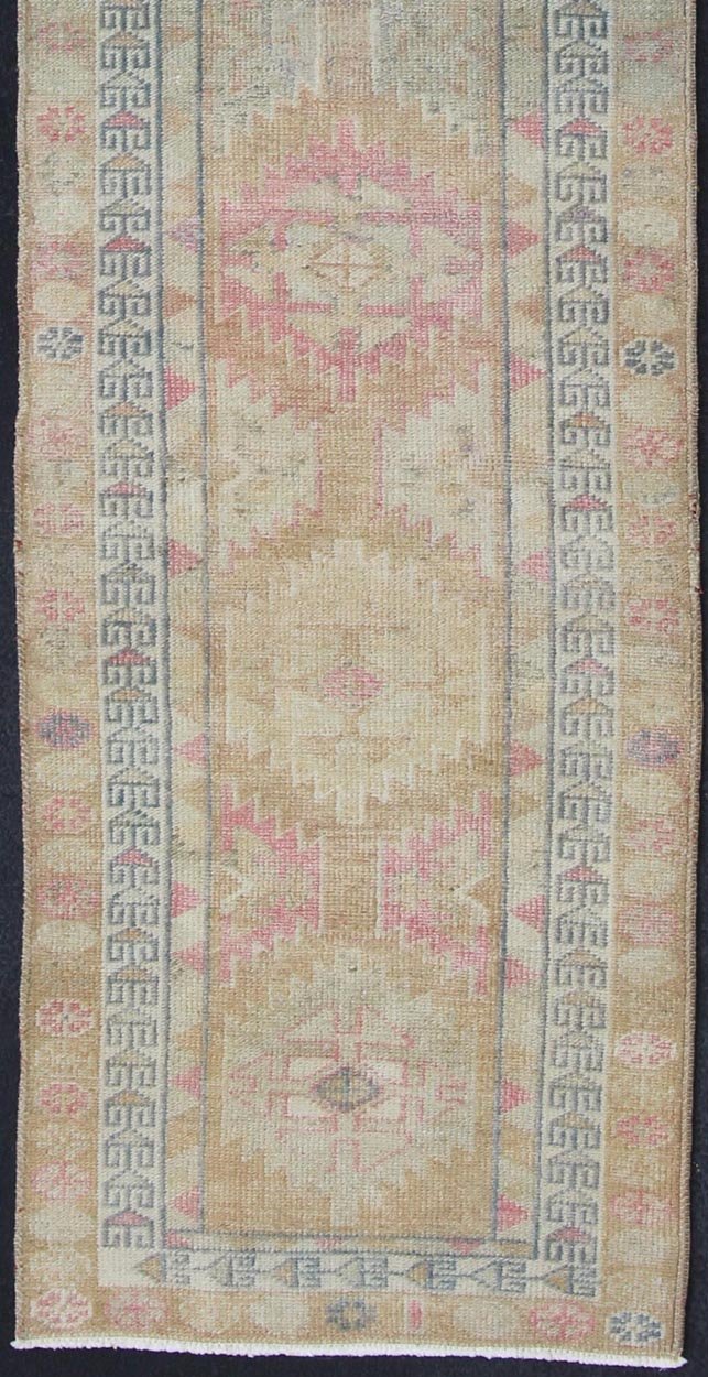 Oushak runner with tribal motifs in blue and pink, rug EN - 165353, country of origin / type: Turkey / Oushak, circa 1960 This Oushak runner from Turkey is characterized by a neutral - toned background and an assortment of tribal designs and flowers... - Keivan Woven ArtsEN - 165353 - 11421Rug