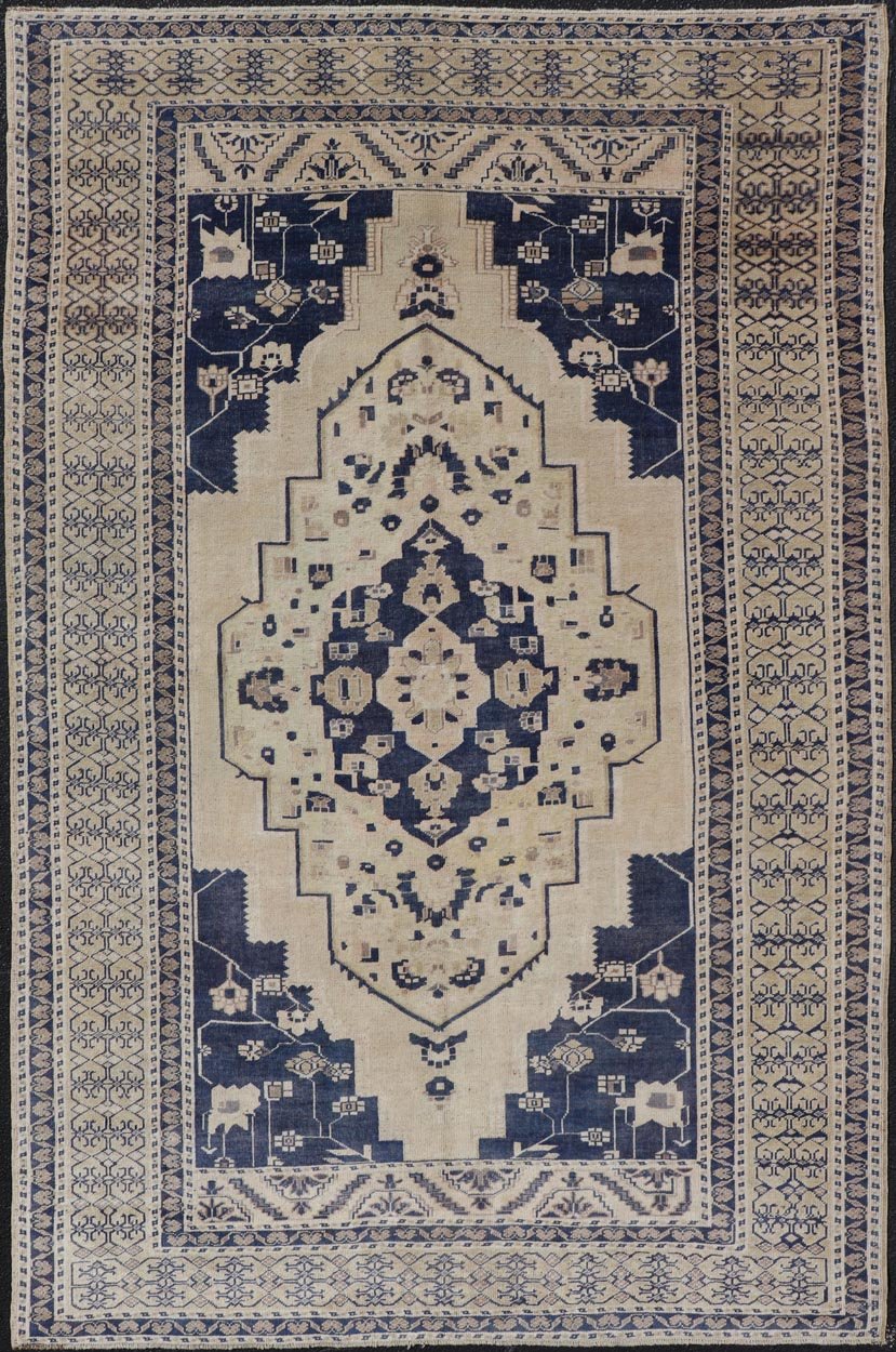 Vintage Hand - Knotted Turkish Oushak in Wool with Sub - Geometric Medallion Design This vintage Turkish Oushak rug has been hand - knotted in wool and features a large central medallion design rendered in blue, cream, tan and ivory tones. A compleme... - Keivan Woven ArtsEN - 178064 - 19508