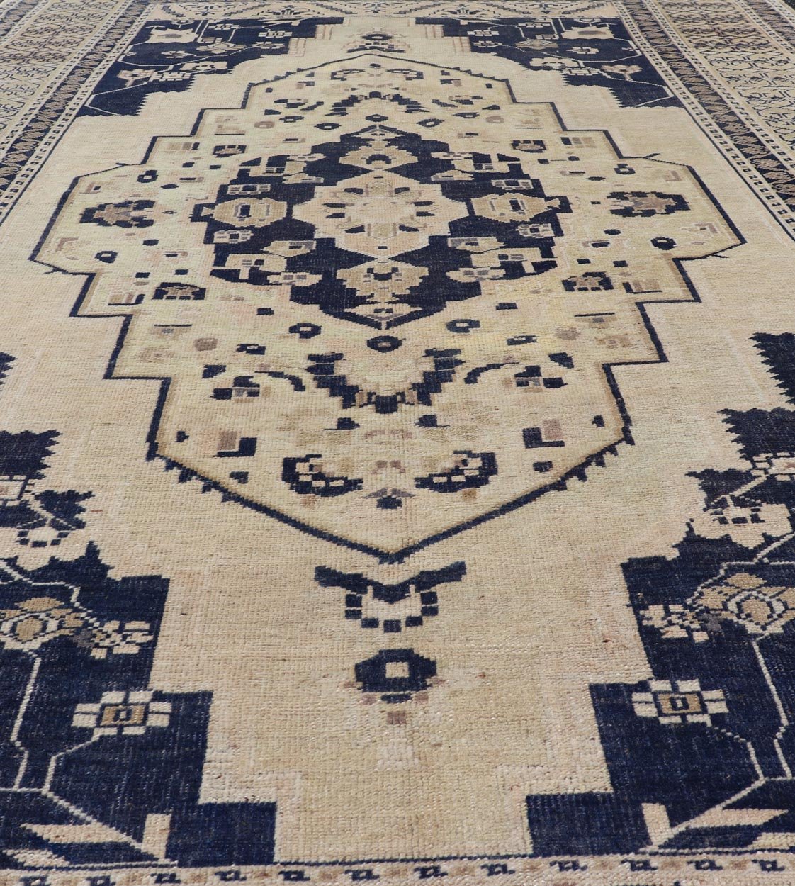 Vintage Hand - Knotted Turkish Oushak in Wool with Sub - Geometric Medallion Design This vintage Turkish Oushak rug has been hand - knotted in wool and features a large central medallion design rendered in blue, cream, tan and ivory tones. A compleme... - Keivan Woven ArtsEN - 178064 - 19508