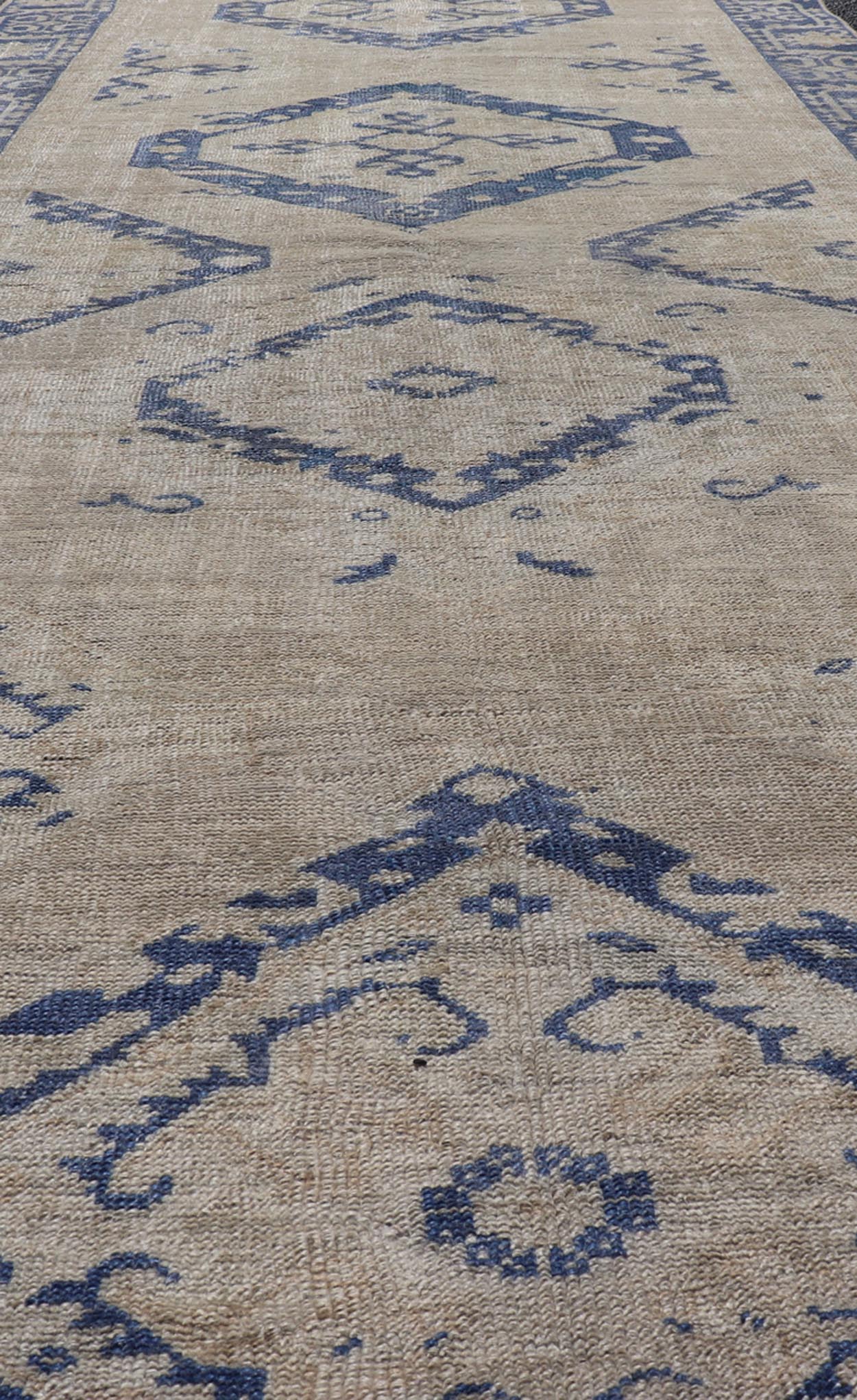 Turkish Oushak Gallery Rug in Blue and Cream with Geometric Design Measures: 4'6 x 12'6 This vintage Oushak gallery runner features blue medallions on a sandy - taupe field. The border and central medallions are both rendered in a rich me... - Keivan Woven ArtsEN - 178699 - 18896Rug