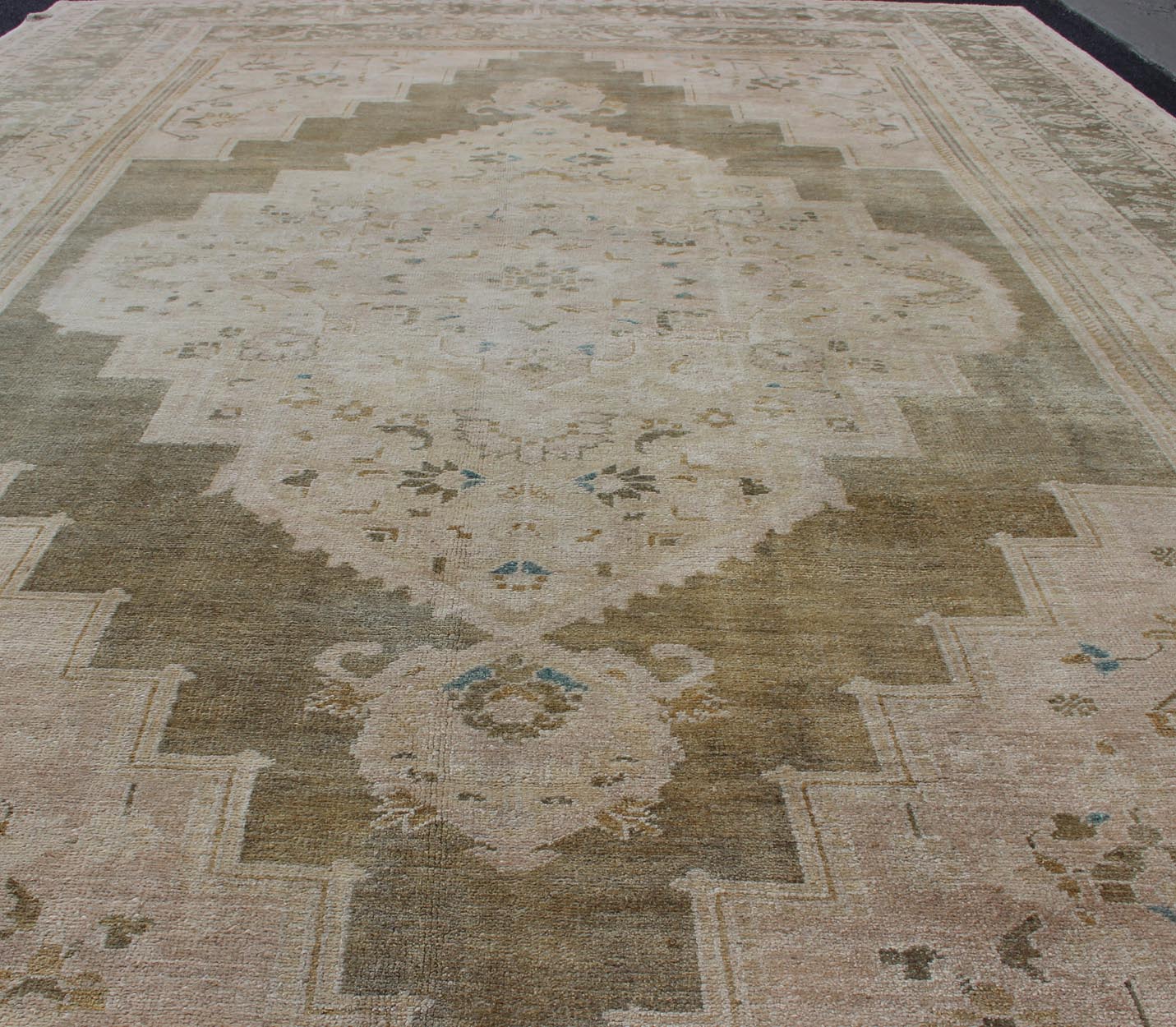Medallion Vintage Turkish Oushak Rug in Olive Green, Army Green, Tan, Teal & Yellow and Muted Tones. Beautiful and unique color Turkish Oushak vintage in Olive and Army green background and border, and soft tones of tan. taupe, blush yellow and... - Keivan Woven ArtsEN - 179178 - 11992Rug