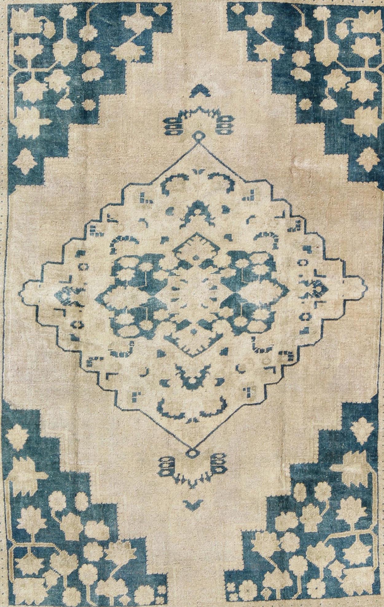 Turkish Oushak Rug This geometric Turkish Oushak carpet rests beautifully upon an ivory background with a cream border. A blue outlined medallion takes center stage and is well balanced by four organic corner motifs composed of the same blue and... - Keivan Woven ArtsEN - 240 - 3064Rug