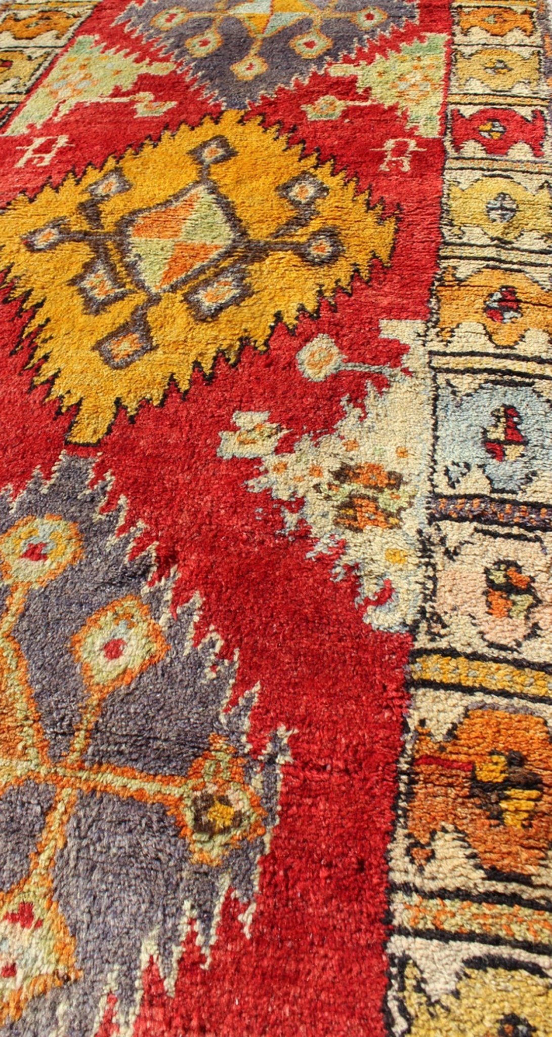 Tribal Turkish Oushak Runner This cheerful Oushak runner contains a unique blend of colors along with geometric design. The multi - layered diamond medallions are complemented by asymmetrical and tribal motifs. The various shades of yellow, gold, ... - Keivan Woven ArtsEN - 3308 - 5498Rug
