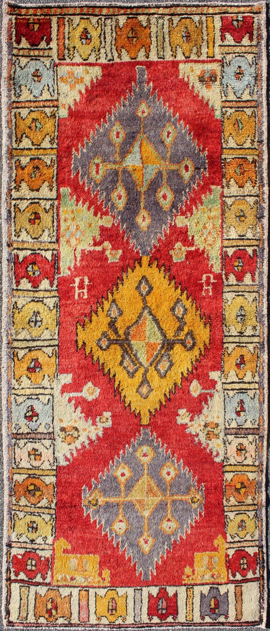 Tribal Turkish Oushak Runner This cheerful Oushak runner contains a unique blend of colors along with geometric design. The multi - layered diamond medallions are complemented by asymmetrical and tribal motifs. The various shades of yellow, gold, ... - Keivan Woven ArtsEN - 3308 - 5498Rug