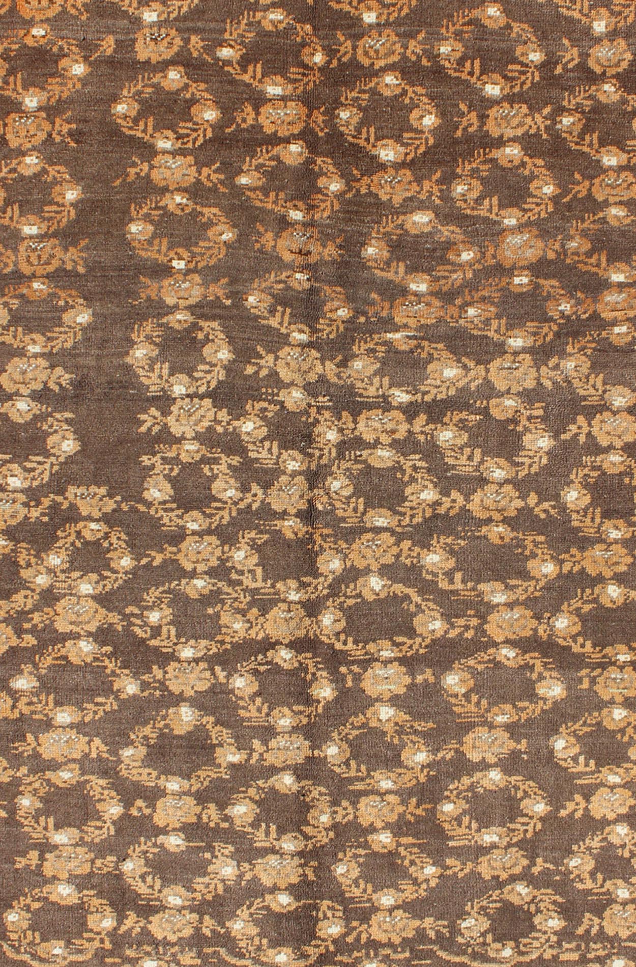 All - Over Floral Wreath Design Turkish Oushak Rug with Brown Background Measures: 4'5 x 7'4 The design of this beautiful vintage Oushak rug from mid - 20th century Turkey is enhanced by its rich colored wool. The brown ground is home to an a... - Keivan Woven ArtsEN - 534 - 3678Rug