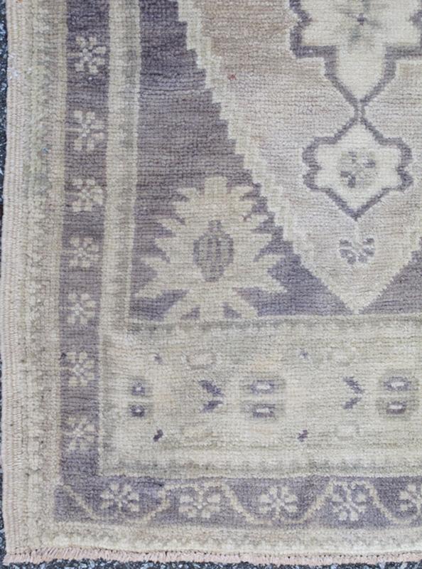 Vintage Turkish Oushak Carpet with Medallion in Dark Gray/Purple and Ivory This Turkish Oushak carpet features a central medallion design, as well as patterns of smaller geometric shapes and botanical elements. The rug's qualities are enhanced b... - Keivan Woven ArtsEN - 713 - 3840Rug