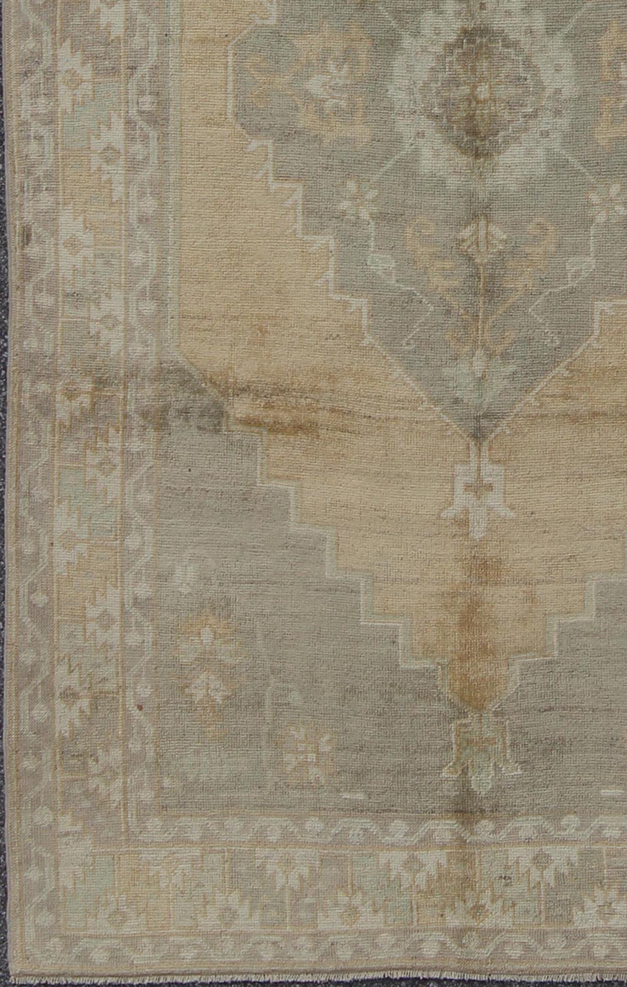 Muted Mid - 20th Century Vintage Oushak Rug with Medallion in Camel Measures: 5'5 x 9'4 This muted Turkish Oushak rests beautifully on a grounded camel - colored field. An understated medallion is well - balanced by four organic corner motifs, ... - Keivan Woven ArtsEN - 721 - 9236Rug