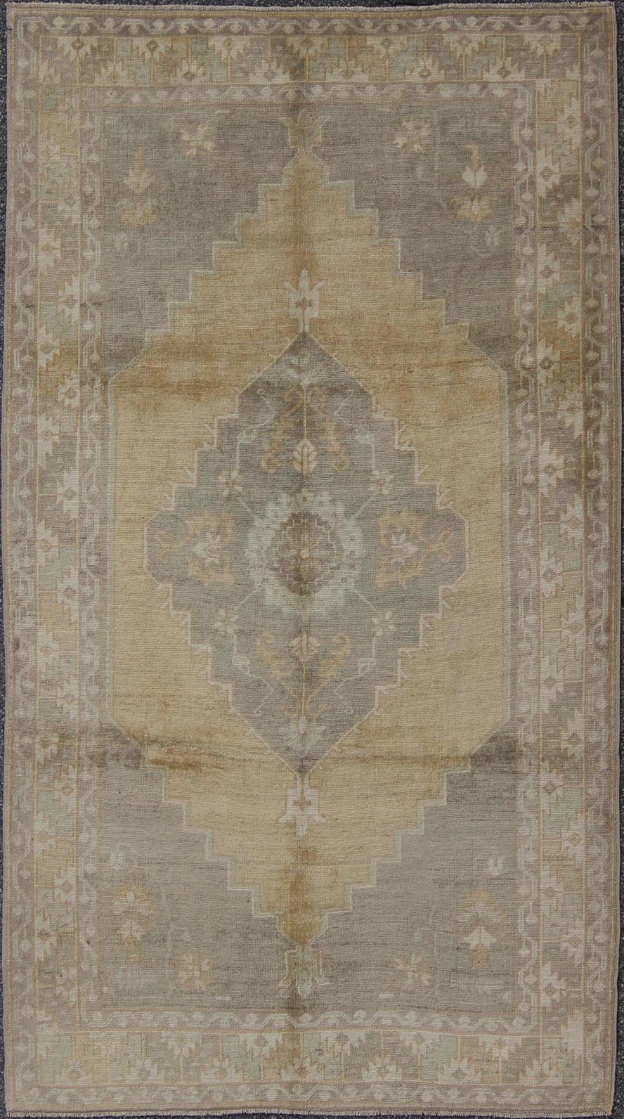 Muted Mid - 20th Century Vintage Oushak Rug with Medallion in Camel Measures: 5'5 x 9'4 This muted Turkish Oushak rests beautifully on a grounded camel - colored field. An understated medallion is well - balanced by four organic corner motifs, ... - Keivan Woven ArtsEN - 721 - 9236Rug
