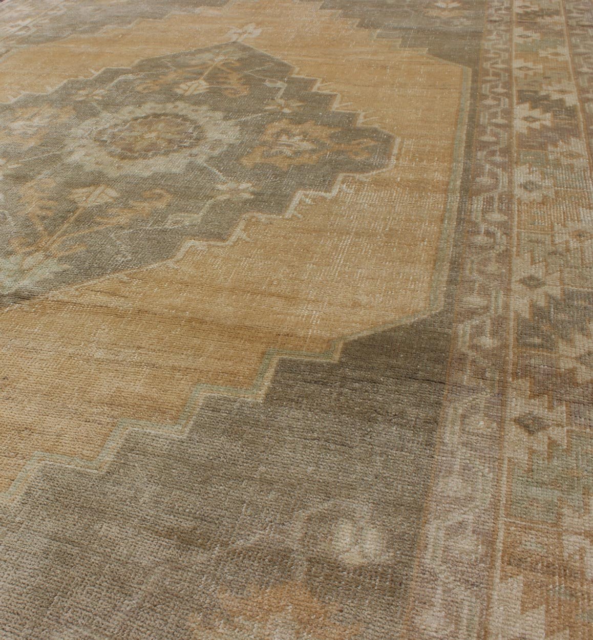 Muted Mid - 20th Century Vintage Oushak Rug with Medallion in Camel Measures: 5'5 x 9'4 This muted Turkish Oushak rests beautifully on a grounded camel - colored field. An understated medallion is well - balanced by four organic corner motifs, ... - Keivan Woven ArtsEN - 721 - 9236Rug