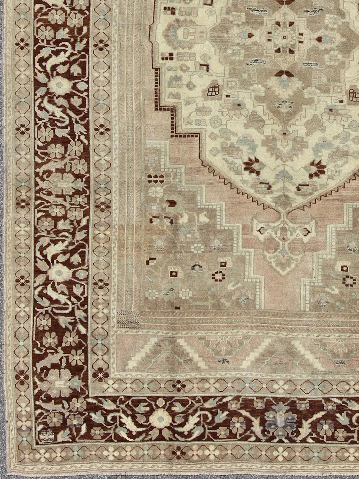 Charming Vintage Oushak Rug in Brown Border, Taupe, Blush and Gray/Green This rug showcases a large central medallion surrounded by a gentle pink color. A cream medallion is filled with floral designs of pale blue, light green, and shades of ne... - Keivan Woven ArtsEN - 786 - 3806Rug