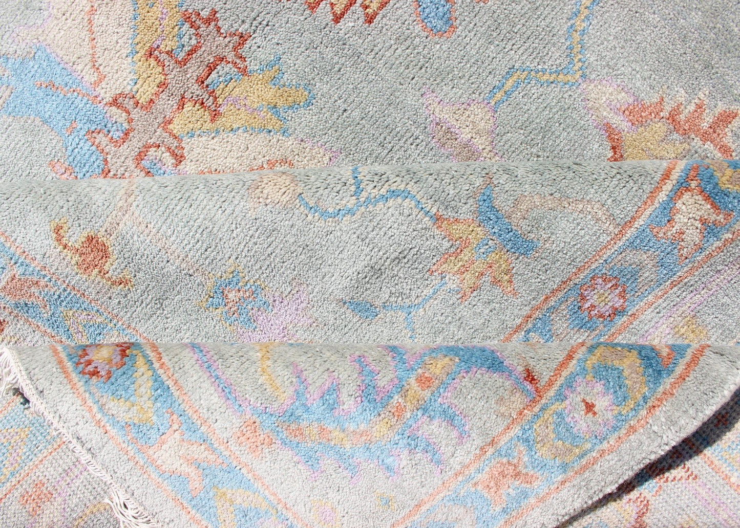 Hand - Knotted Floral Oushak Designed Rug in Light Blue, Orange, and Blue Measures 9'1 x 11'8 This wool Oushak was hand - knotted in the 2020's. The field and border both have a cool blue gray. The field and border also share floral and leaf... - Keivan Woven ArtsIN - CLR - 1002 - 13444