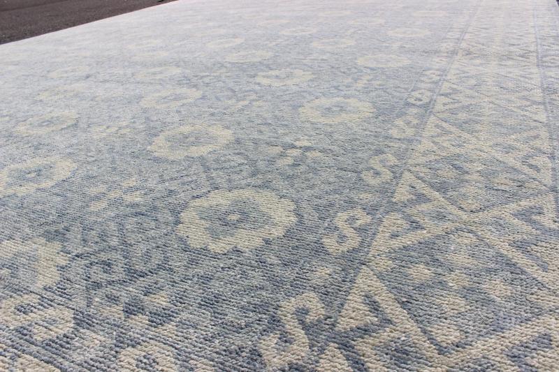 Vintage Khotan Rug in White and Blue. Measures: 9'2 x 12'1. This superb woolen Khotan hailing from India features an all over design with geometric shapes and patterning enclosed within a complementary border. The rug is rendered in shades of whi... - Keivan Woven ArtsIN - JAI - 5385 - 6967Rug