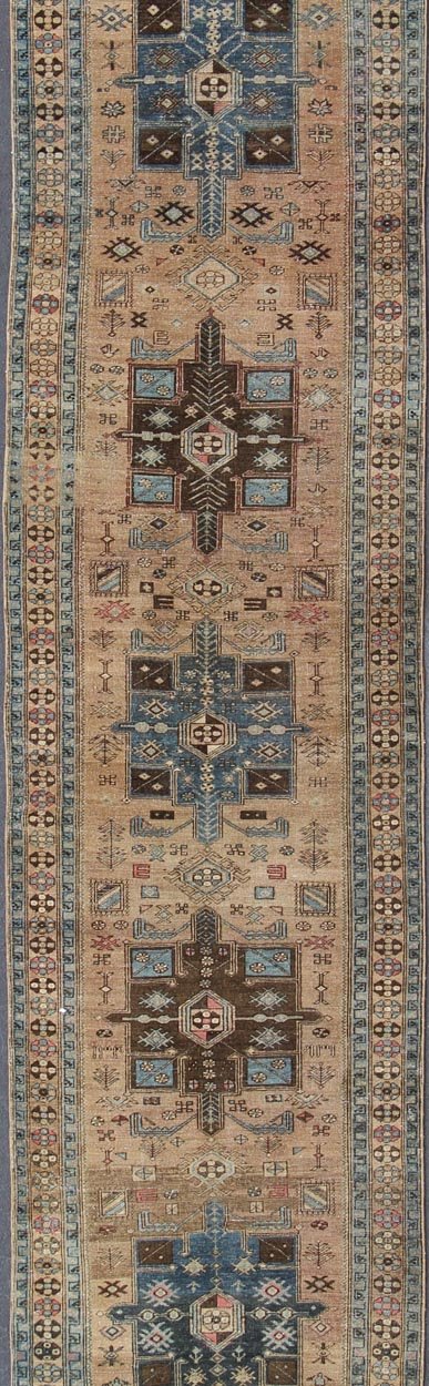 Geometric Medallion Heriz Long Antique Runner in Tan, Brown & Blue Geometric Medallion Heriz long antique runner in tan, brown and blue, rug H - 405 - 11, country of origin / type: Heriz, circa 1930. This magnificent antique Persian Heriz carpet from... - Keivan Woven ArtsKB - H - 405 - 11 - 1314Rug