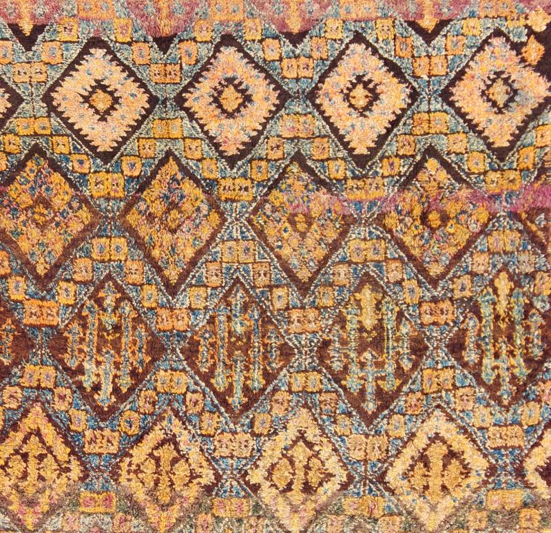 Vintage Square Moroccan Beni Ouarain In Earthy Tones With Pops of Blue and Gold Measures: 7'9'' x 8'4''. This piece is a thick and lush vintage tribal Moroccan carpet which originated from the northern Middle Atlas mountains. The weavers of t... - Keivan Woven ArtsLCB - 136638 - 7329Rug
