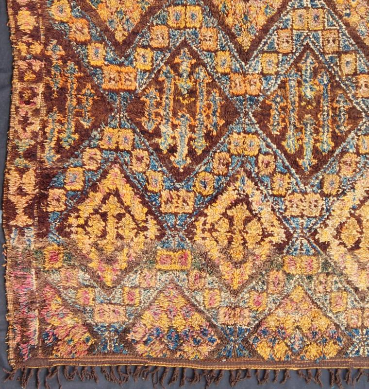 Vintage Square Moroccan Beni Ouarain In Earthy Tones With Pops of Blue and Gold Measures: 7'9'' x 8'4''. This piece is a thick and lush vintage tribal Moroccan carpet which originated from the northern Middle Atlas mountains. The weavers of t... - Keivan Woven ArtsLCB - 136638 - 7329Rug