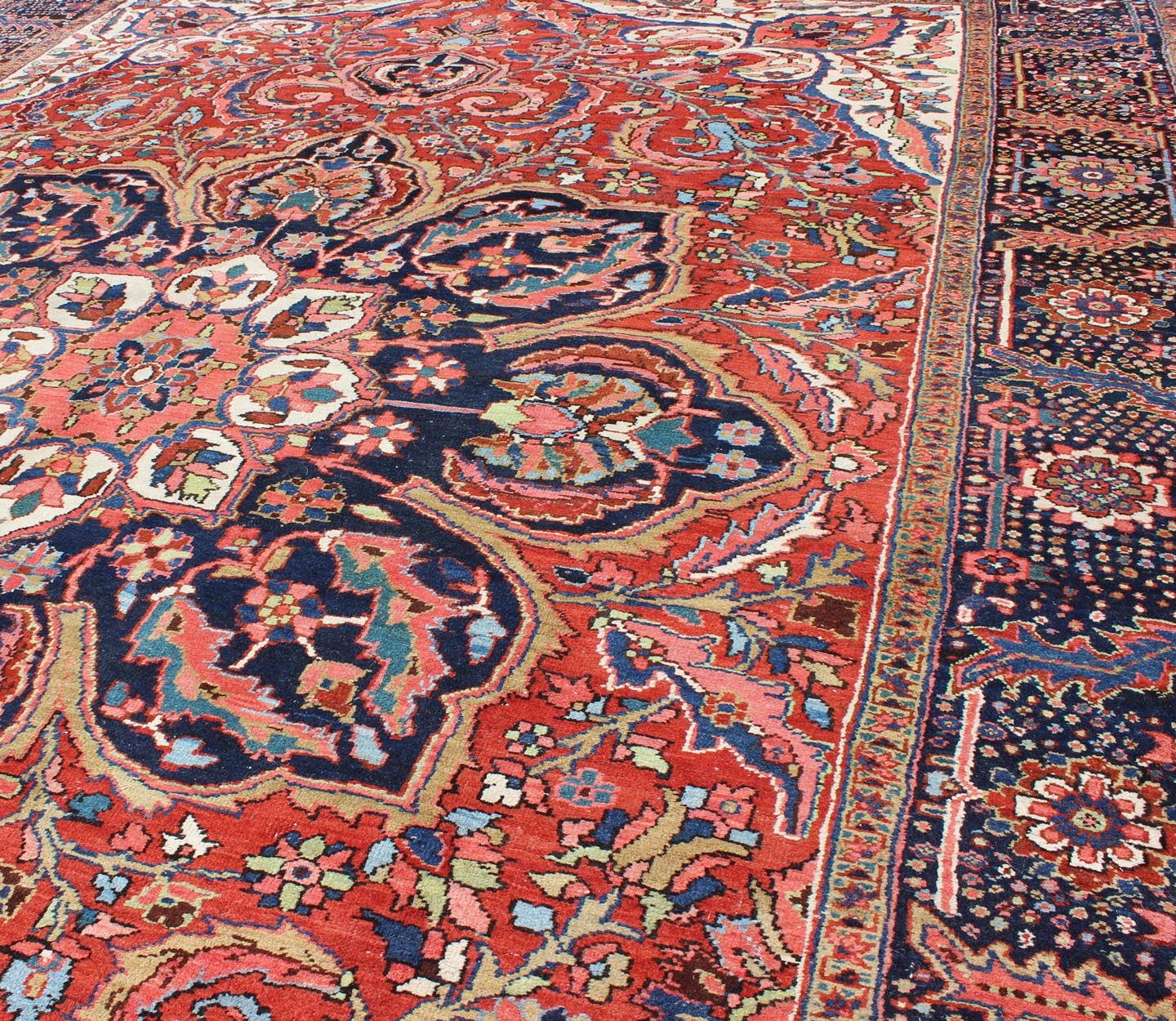 Large Persian Heriz Rug with Geometric Medallion in Rust, Pink, Green and Blue. Keivan Woven Arts / Rug / M14 - 0501, country of origin / type: Iran /Heriz, circa 1930. Measures: 10'1 x 13'5. Masterful craftsmanship and a strong tribal design make... - Keivan Woven ArtsM14 - 0501 - 5371Rug