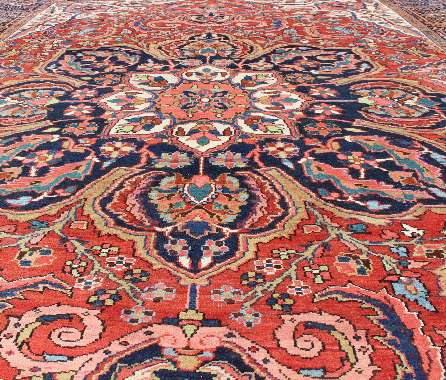 Large Persian Heriz Rug with Geometric Medallion in Rust, Pink, Green and Blue. Keivan Woven Arts / Rug / M14 - 0501, country of origin / type: Iran /Heriz, circa 1930. Measures: 10'1 x 13'5. Masterful craftsmanship and a strong tribal design make... - Keivan Woven ArtsM14 - 0501 - 5371Rug