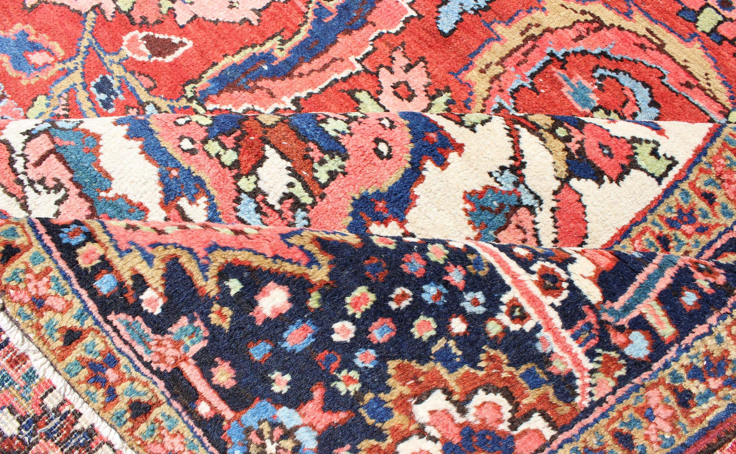Large Persian Heriz Rug with Geometric Medallion in Rust, Pink, Green and Blue. Keivan Woven Arts / Rug / M14 - 0501, country of origin / type: Iran /Heriz, circa 1930. Measures: 10'1 x 13'5. Masterful craftsmanship and a strong tribal design make... - Keivan Woven ArtsM14 - 0501 - 5371Rug