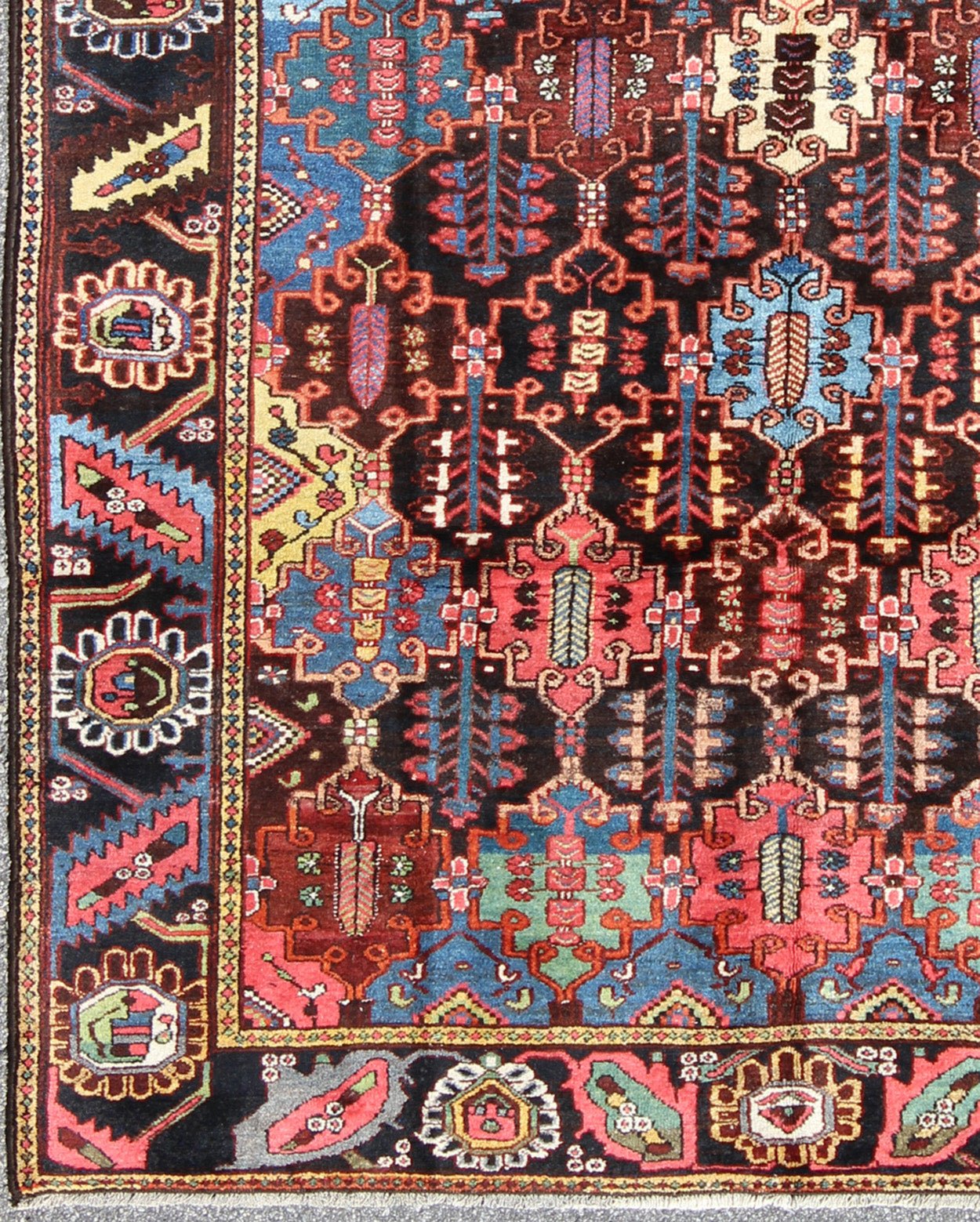Vintage Persian Bakhtiari Rug This vintage Bakhtiari has an all - over garden pattern. The repeating border of flowers and vines include yellow, blue and red set on a brown background. Measures: 7'3 x 9'7. - Keivan Woven ArtsM14 - 0514 - 5385Rug