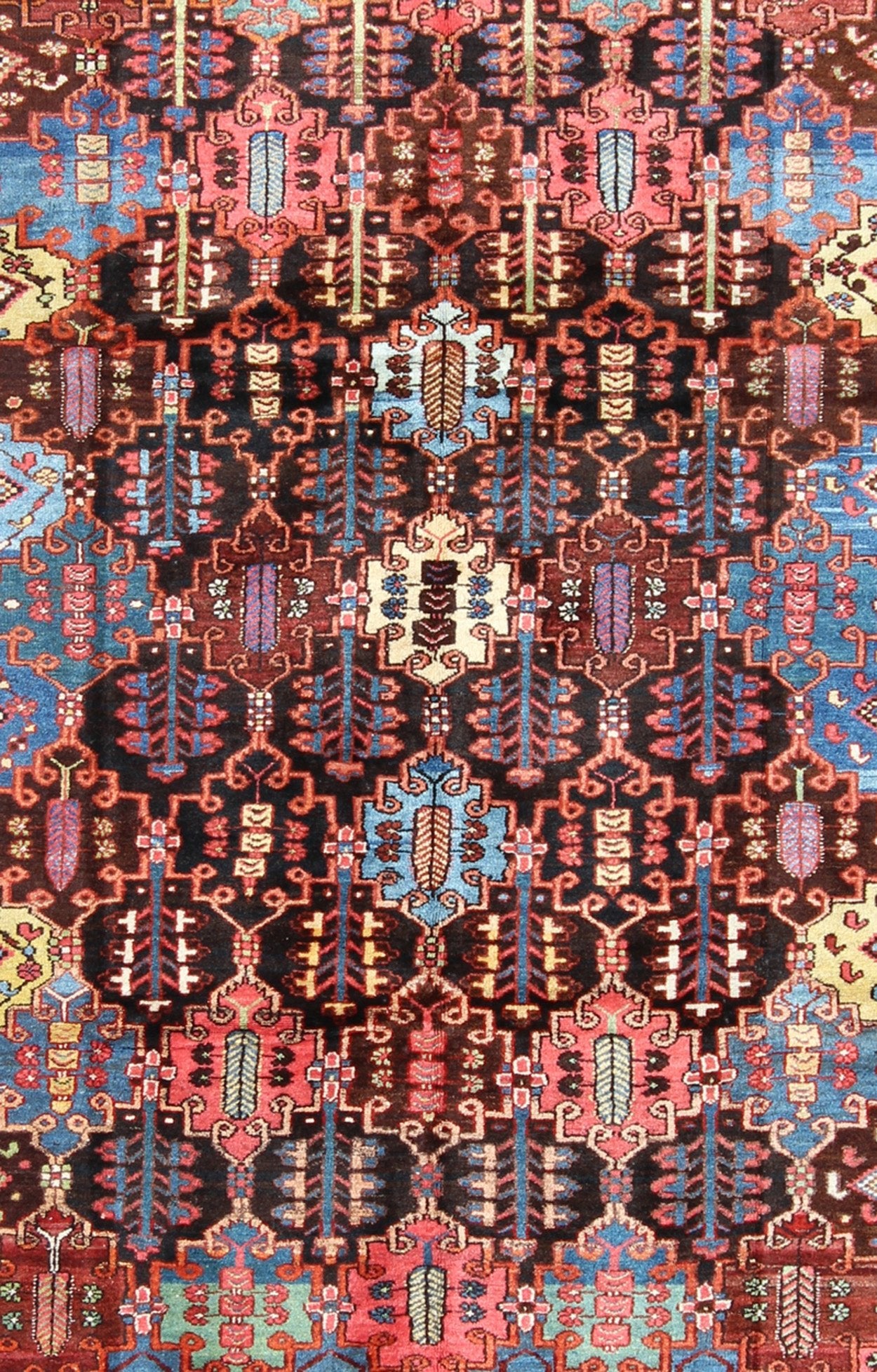 Vintage Persian Bakhtiari Rug This vintage Bakhtiari has an all - over garden pattern. The repeating border of flowers and vines include yellow, blue and red set on a brown background. Measures: 7'3 x 9'7. - Keivan Woven ArtsM14 - 0514 - 5385Rug