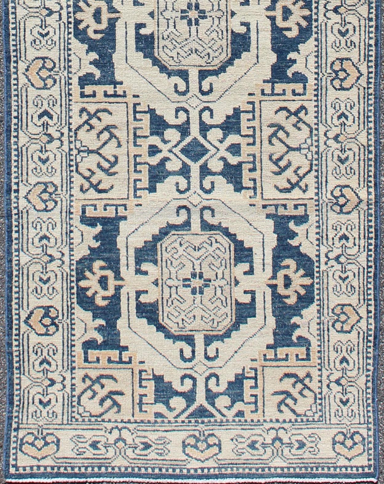 Vintage Khotan Rug with Geometric Medallions in Navy and Cream Tones Khotan with Geometric Medallions, rug MP - 1310 - 93, country of origin / type: Afghanistan / Khotan, circa Early - 21st Century. Measures: 2'11 x 10'3. This Khotan fe... - Keivan Woven ArtsMP - 1310 - 93 - 4758Rug